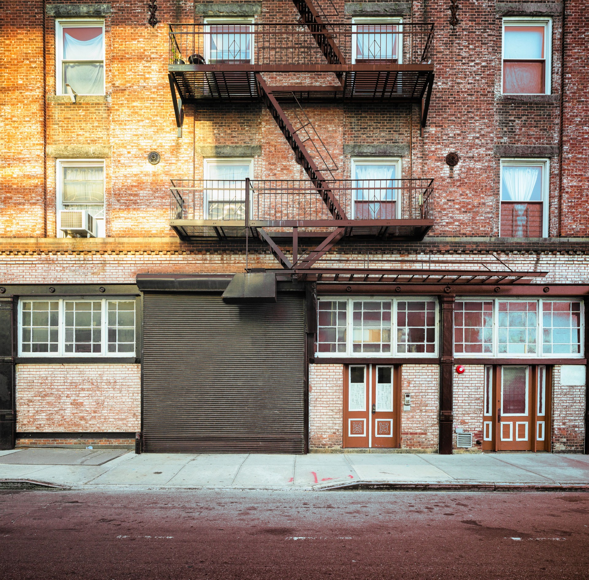 Brooklyn apartment buildings facade with large steel garage door